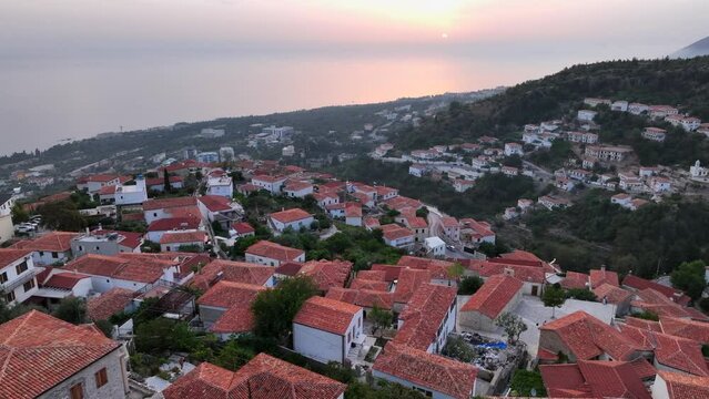 Dhermi at Sunset time. Aerial Shot of Beautiful Village Sea View, Stone Houses, beach Resort in Mountains of Albania