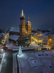 St Mary's church and Christmas tree on the snow covered Main Square in the winter night, Krakow, Poland - 688193464
