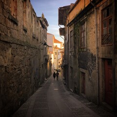 Couple walking down the narrow street in Porto, Portugal, January 2019