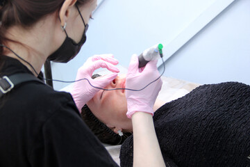 Banner Process woman applying permanent tattoo makeup on lips in beautician salon.