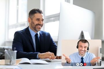 Business people two mature men have online meeting, office interior