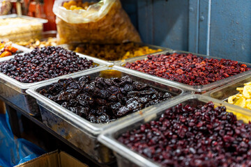 Various kinds of dried fruits are displayed at the Carmel market in Tel Aviv-Jaffa - obrazy, fototapety, plakaty