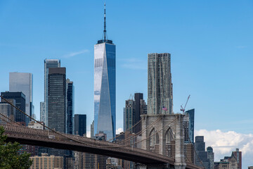 Low angle view from waterfront Brooklyn Bridge Park to the Brooklyn Bridge in Lower Manhattan, New...