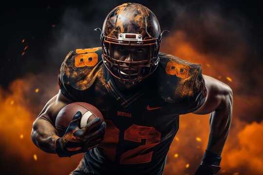 An American football player with a ball in his hand runs against a background of fire .Abstract fire background