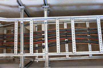 electric cable duct on a metal frame, cable pulling industrial area in a tray , industrial wiring...