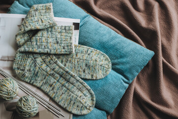 Hand knitted socks with needles and yarn ball. Concept for handmade and hygge slow life.