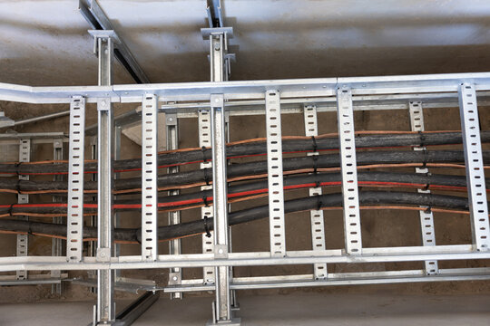electric cable duct on a metal frame, cable pulling industrial area in a tray , industrial wiring rail , knit done