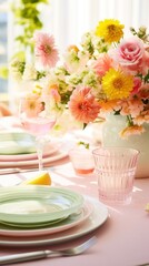 Obraz na płótnie Canvas A table decorated with fresh flowers and pastel-colored tableware invites guests to a lively spring gathering.