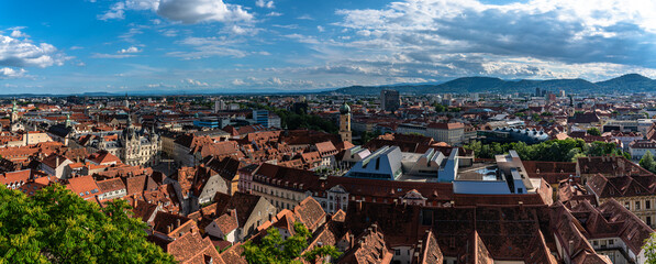 Aerial panorama view of Graz city old town from Castle Hill (Schlossberg) with city hall, main square and Franciscan Church, art museum, on sunny summer day, with blue sky cloud, Graz, Styria, Austria - 688202407