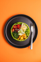 Appetizing bowl with salmon and vegetables sprinkled with sesame seeds