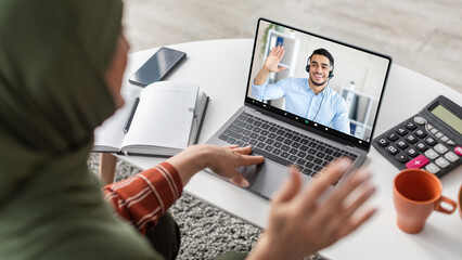 Middle Eastern Woman Video Calling Via Laptop Indoor