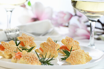 Festive appetizer of puff pastry in the shape of a star, stuffed with salmon and soft cheese. The perfect appetizer for your holiday table.