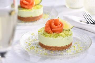 Timbale appetizer made from avocado, whipped with soft cheese cream and lime on short crust pastry...