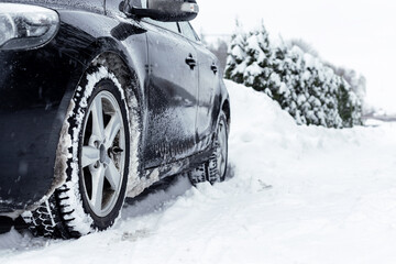 Car on a winter road. Driving in winter. Bad weather conditions.