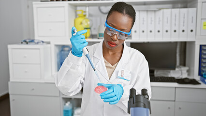 Serious african american woman scientist, beautiful in glasses, boldly pouring liquid into test...