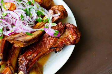 Grilled ribs with marinated onions and grilled vegetables. 