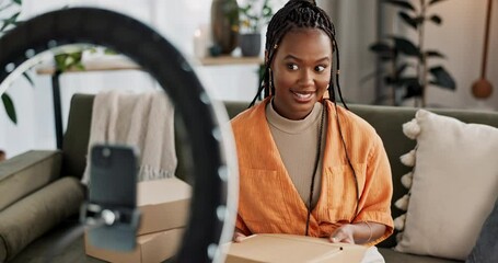 Smile, live streaming and black woman open box with product for beauty makeup. Happy, influencer and person unboxing package with cosmetics, shipping and delivery on social media blog at home on sofa
