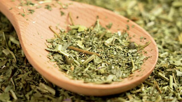 Dried Passiflora herbs for sedative tea. Passion flower organic dry leaves in wooden spoon. Rotation