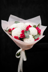 Large bouquet of white chrysanthemums and small red roses, isolated