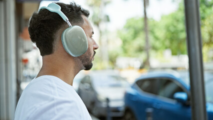 Young arab man listening to music at street