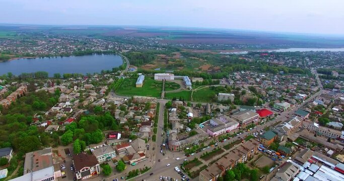 Scenery of usual Ukrainian town at daytime. Top view of the city locating near the river.