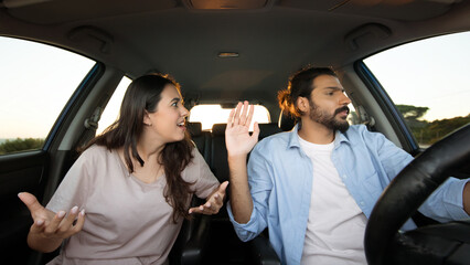 Middle eastern couple arguing in car