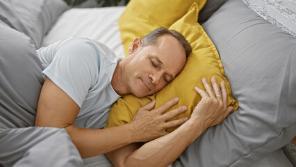 Middle age man lying on bed sleeping at bedroom