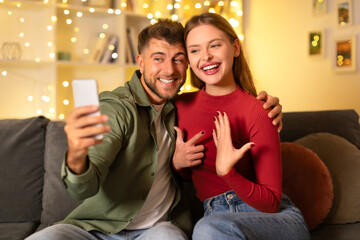 Couple's joyful engagement selfie moment