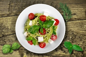 Spring tasty fresh pasta noodles with basil sauce