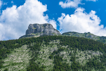 Fototapeta na wymiar Stunning view of the steep cliff of peak Loser above Altaussee lake on a sunny summer day with blue sky cloud, Salzkammergut-Ausseerland region, Styria, Austria