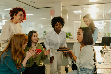 A diverse colleagues and friends celebrating birthday at office.