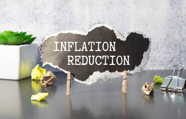 notepad ,chart and calculator. Top view text INFLATION REDUCTION.