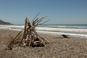 a stick wigwam on beach New Zeland