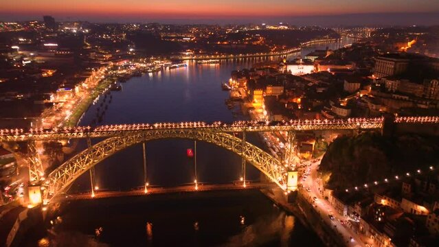 Aerial view of Porto with Luis I Bridge and Douro River at night. High quality 4k footage