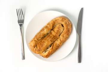 Meat Pie or Burek, traditional dish of Balkans, Middle East and Central Asia isolated on white background. Thin flaky dough filled with meat