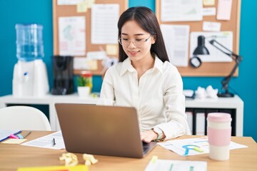 Young chinese woman business worker using laptop working at office