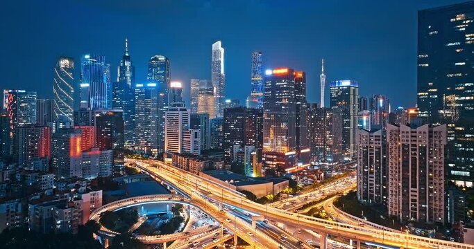 Aerial shot of city buildings skyline and road intersection at night in Guangzhou, Guangdong Province, China