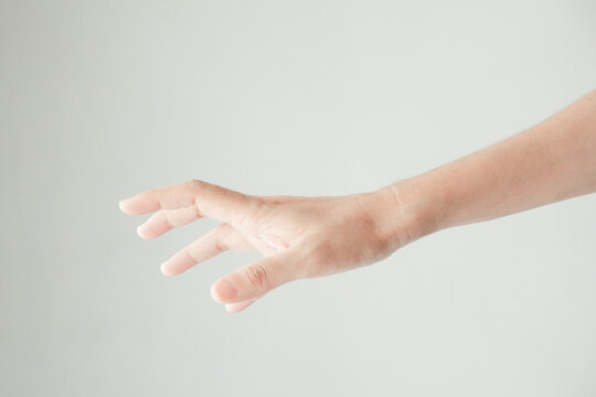 A male hand reaches for something or points to something isolated on a white background. Isolated hand reaching out. Photo for body part hand.