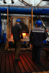 Fototapeta na wymiar Steel part quenching at high temperature in industrial furnace