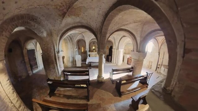 Monteveglio, Bologna, Italy - Nov 25, 2023: crypt of Santa Maria Assunta Abbey in Monteveglio, divided into four bays by columns and pillars, houses central tombstone and three altars within its apses