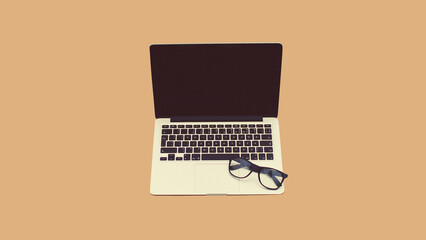Close up laptop with blank black screen and eyeglasses on brown background