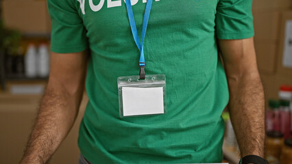 Young hispanic man volunteer standing at charity center