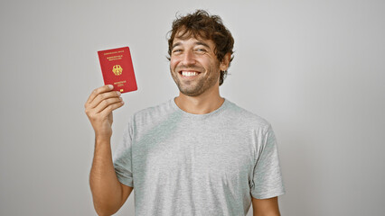 Happy young hispanic man, confidently smiling with joy, casually holds his german passport against...