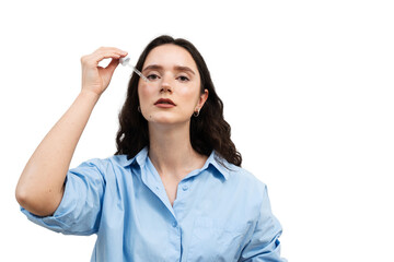 Young woman is applying moisturizing serum on her face on white background. Girl is dropping...