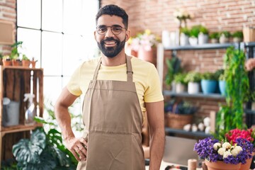 Young arab man florist smiling confident standing at florist