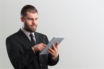 Smart caucasian freelancer professor using  tablet computer