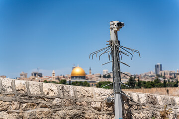 Surveillance camera in Jerusalem with the Dome of the Rock in the background