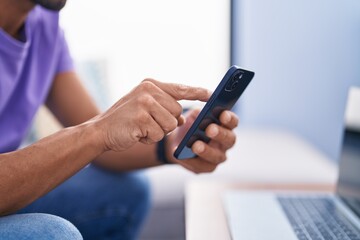 Young bald man using smartphone at street
