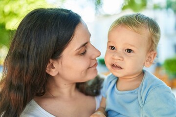 Mother and son smiling confident standing at park