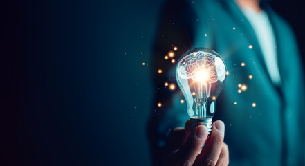 New idea innovation concept, man holding Light bulbs with Brain inside. Creative and innovation inspiration. Business Bright idea concept.